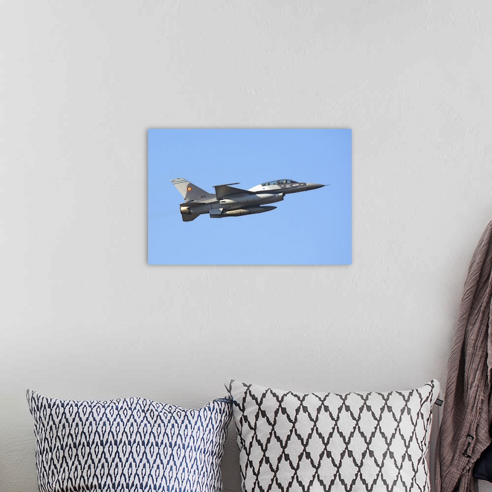 A bohemian room featuring Romanian Air Force F-16B Block 20 MLU takes off from Aviano Air Base, Italy, after a fuel stop du...