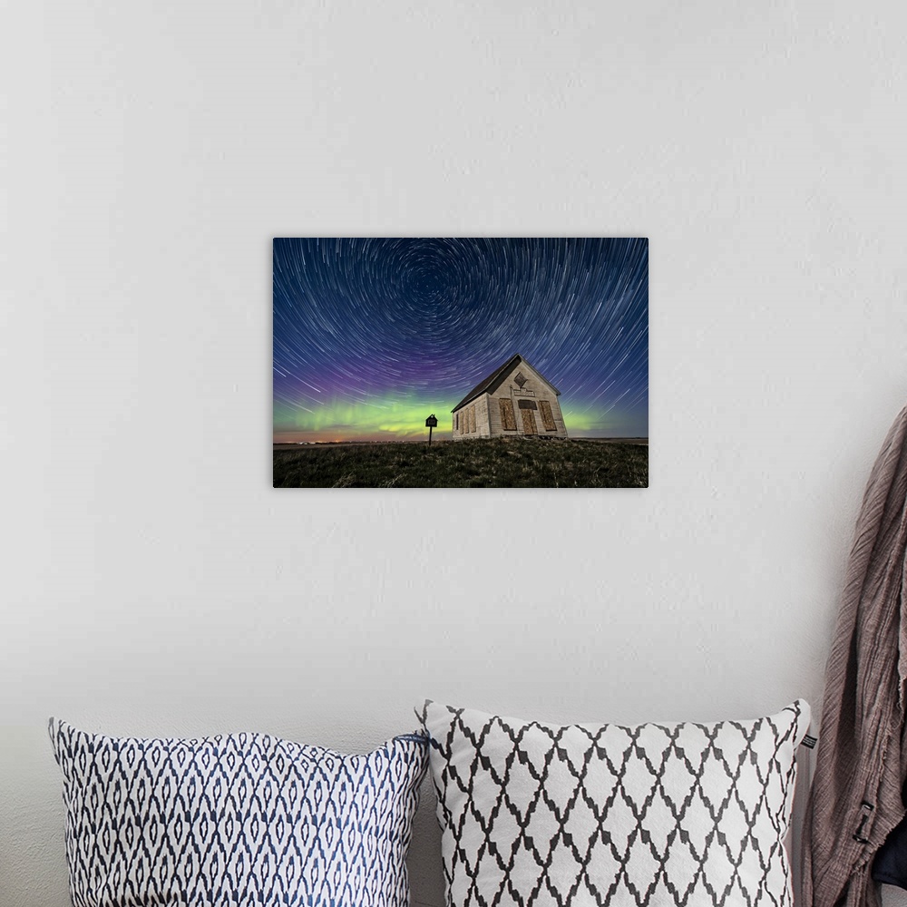 A bohemian room featuring Star trails above the 1910 Liberty Schoolhouse in Alberta, Canada.