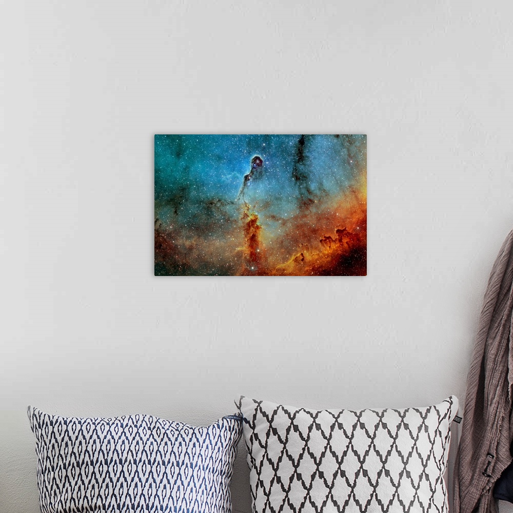 A bohemian room featuring Large photograph showcases a concentration of interstellar gas and dust within the much larger io...