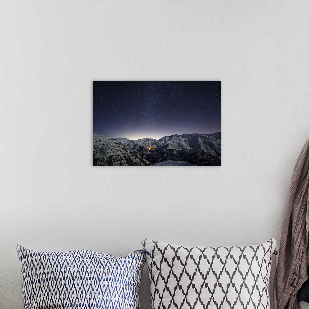 A bohemian room featuring The winter Milky Way shines above the snow-covered  Alborz Mountain Range in Iran.