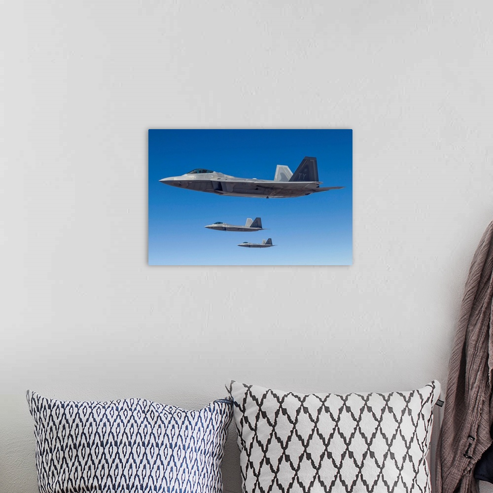 A bohemian room featuring Three U.S. Air Force F-22 Raptors cruise above Nevada.