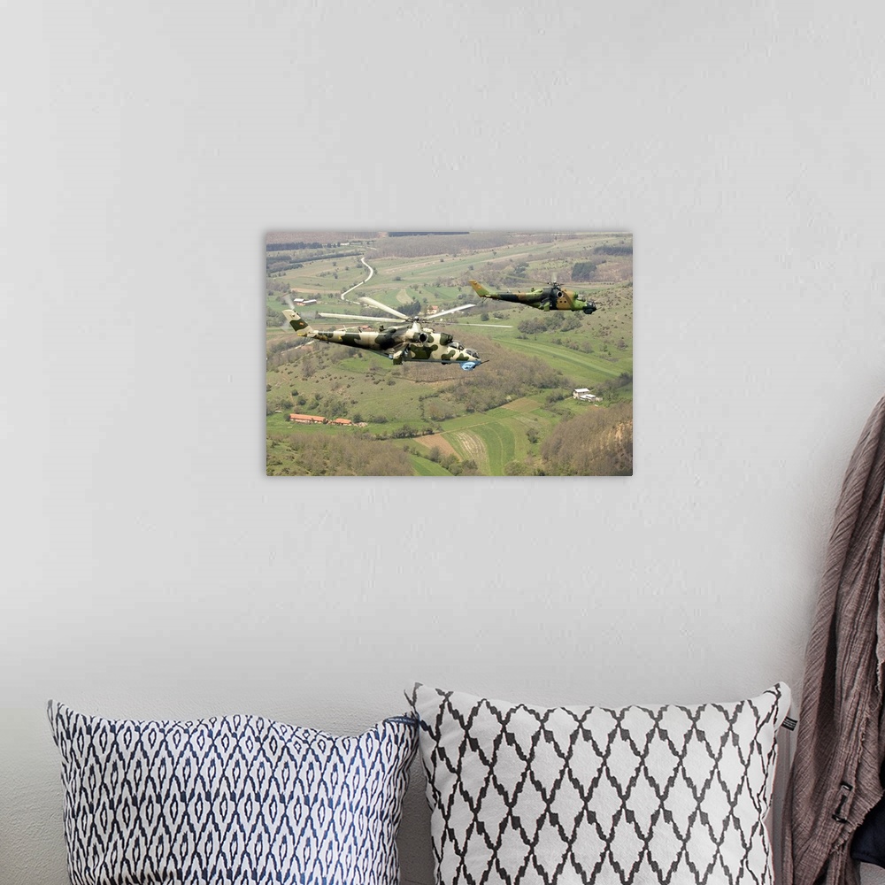 A bohemian room featuring Two Mi-24V Hinds of the Combat Helicopter Squadron of the Macedonian Air Force.