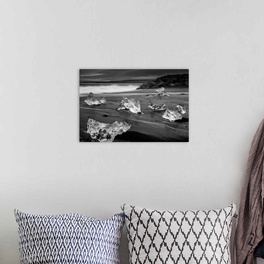 A bohemian room featuring Fragments of ice on the dark sand on the Icelandic coast.