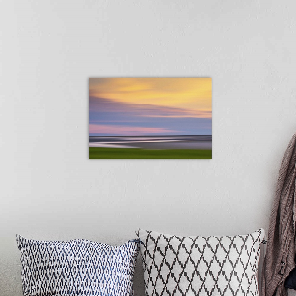 A bohemian room featuring Blurred image of the Atlantic coast at sunset, with a pastel cloudy sky.