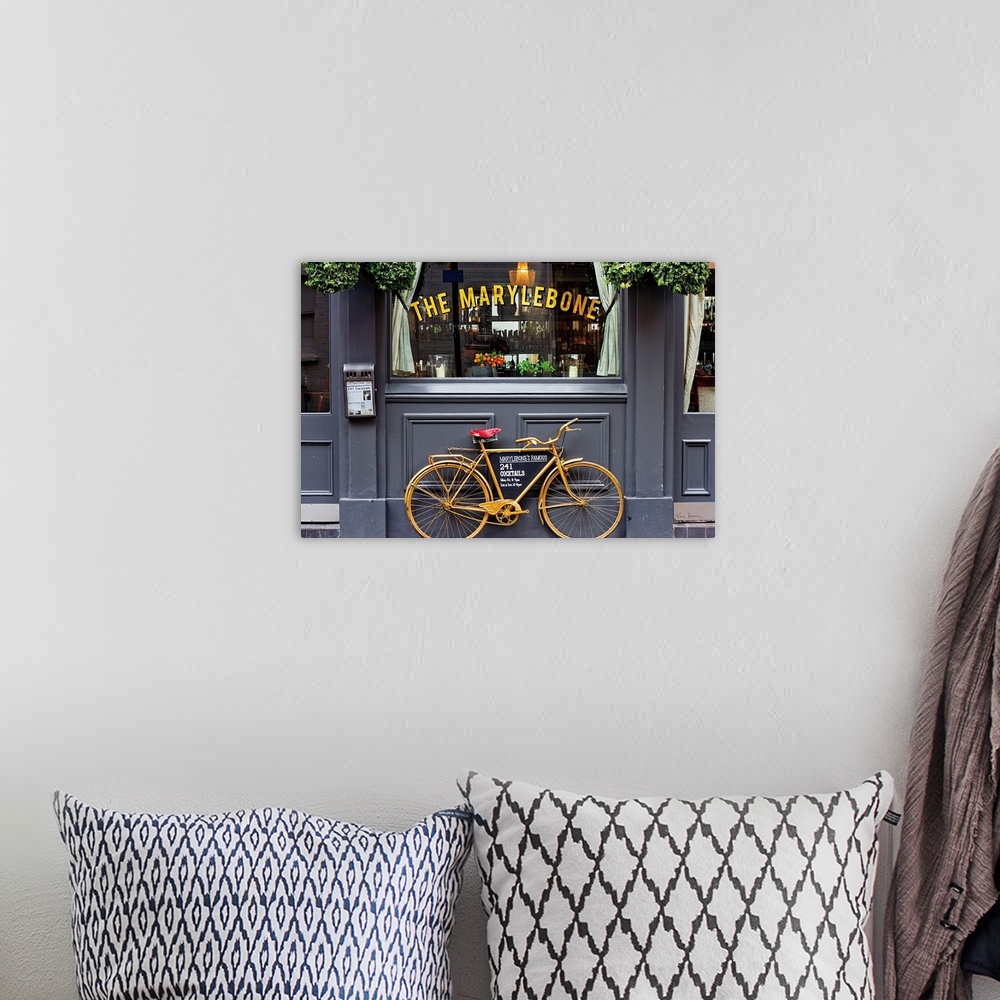 A bohemian room featuring Photograph of a gold bike leaning up against The Marylebone, advertising their cocktails, London,...