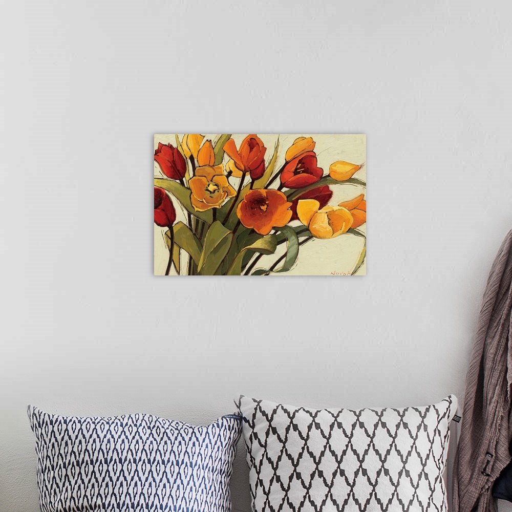 A bohemian room featuring A horizontal painting that is a close up of a floral arrangement with warm, sunshiny colors.