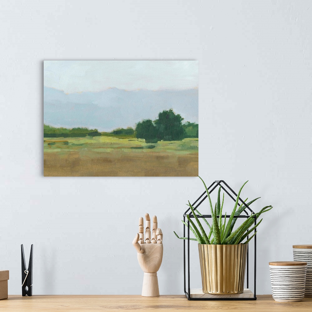 A bohemian room featuring Contemporary landscape painting in green and brown with a mountain range in the distance.