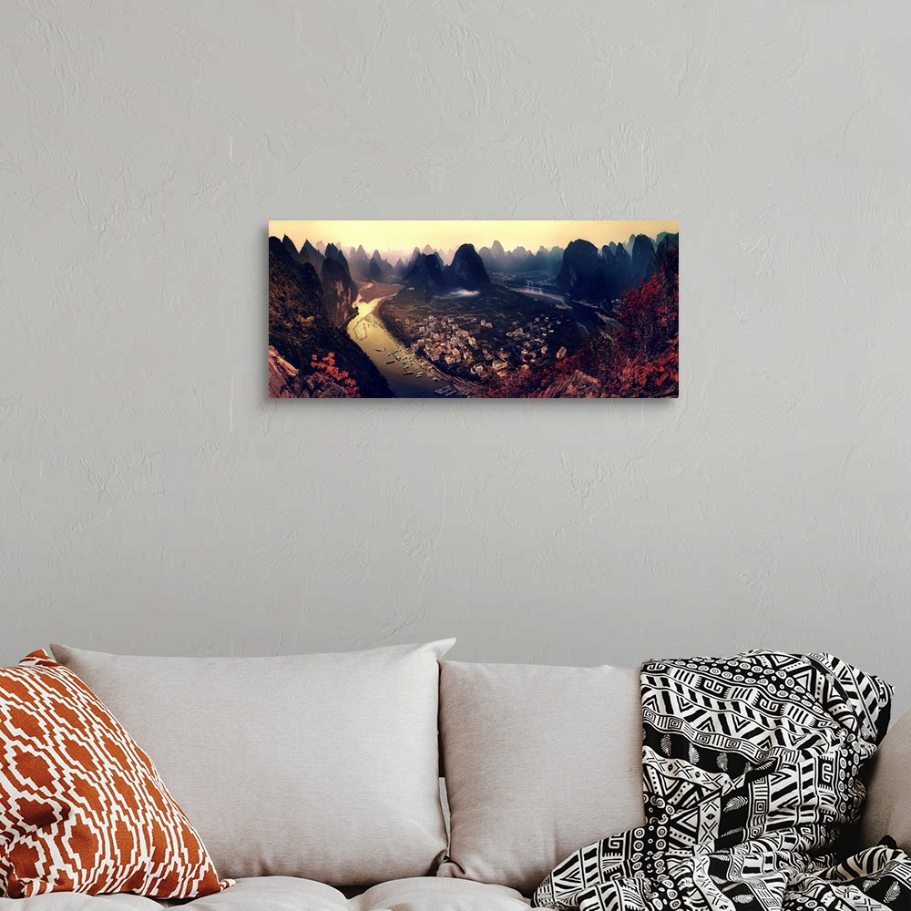 A bohemian room featuring A dynamic and intense photograph of a view of the Karst mountains in Guangxi, China.