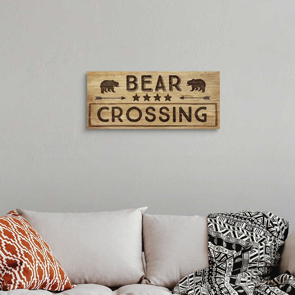 A bohemian room featuring Contemporary cabin decor artwork of a wooden sign for Bear Crossing.