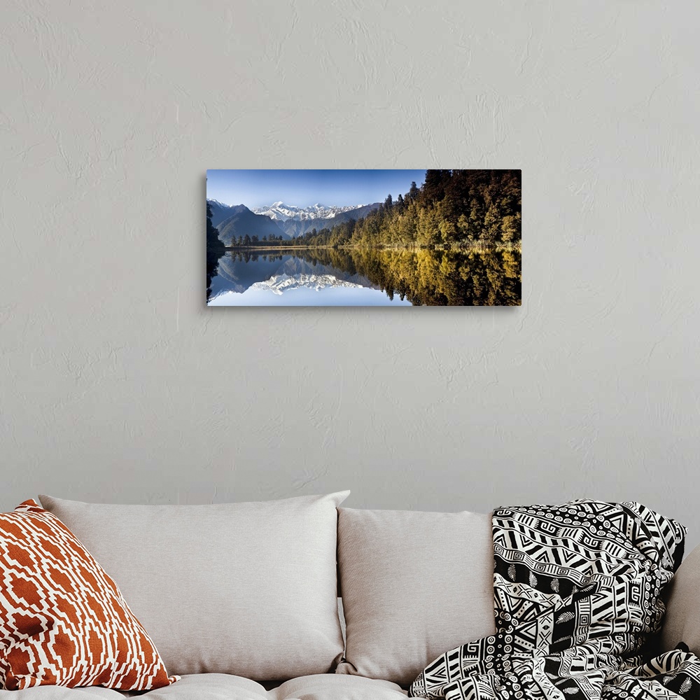 A bohemian room featuring Mount Cook and Mount Tasman reflected in Lake Matheson at sunset near Fox Glacier, New Zealand