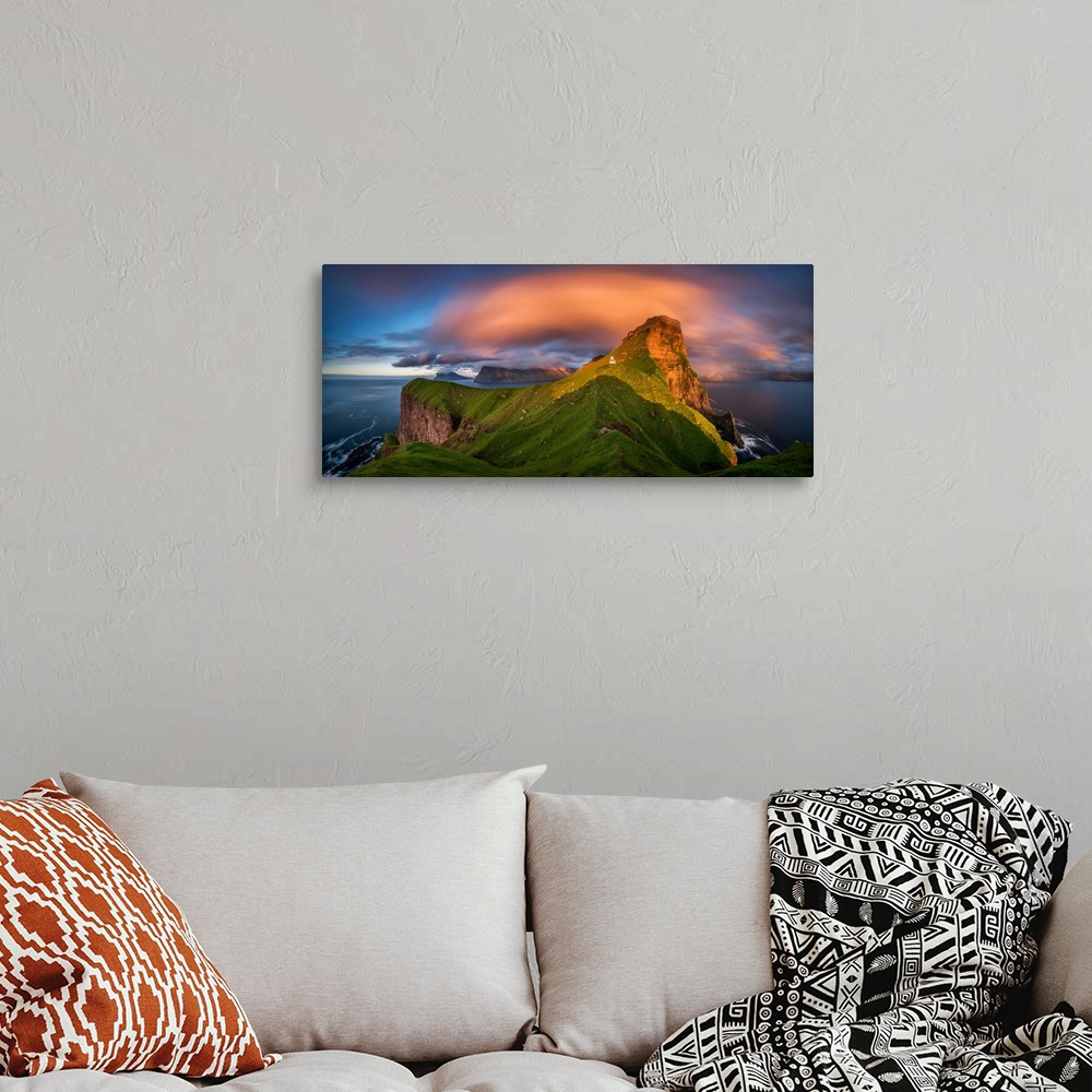 A bohemian room featuring Kalsoy island and kallur lighthouse at sunset, faroe islands, denmark.