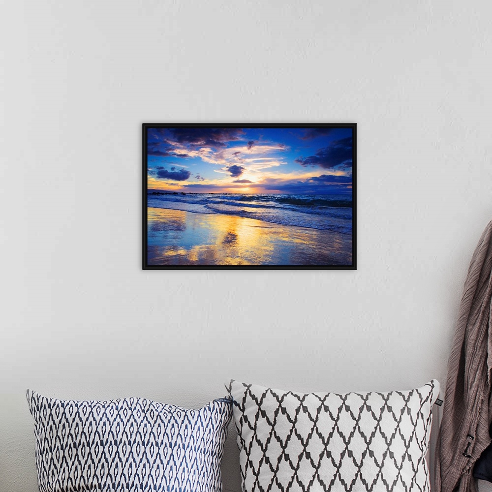 A bohemian room featuring Horizontal photograph on a large wall hanging of a vivid sunset glowing through clouds, over the ...