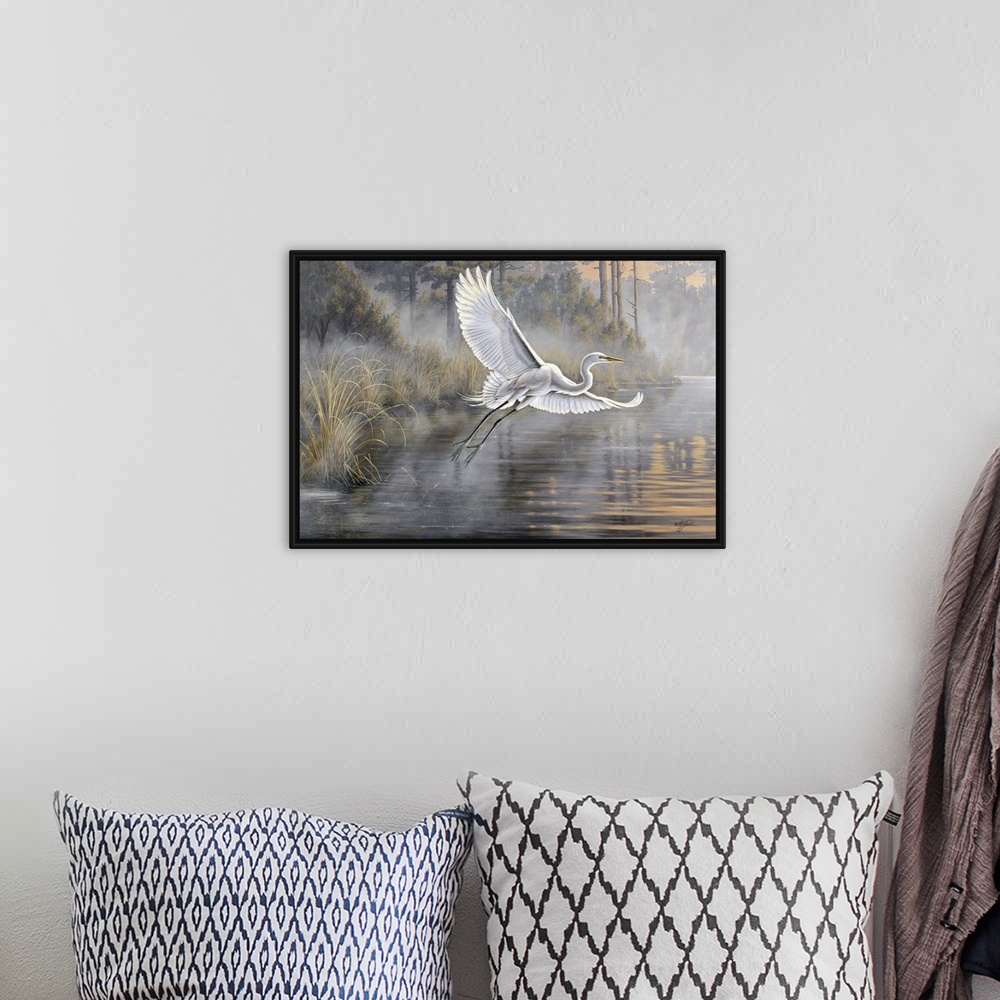 A bohemian room featuring Great white egret flying over a pond at sunrise.