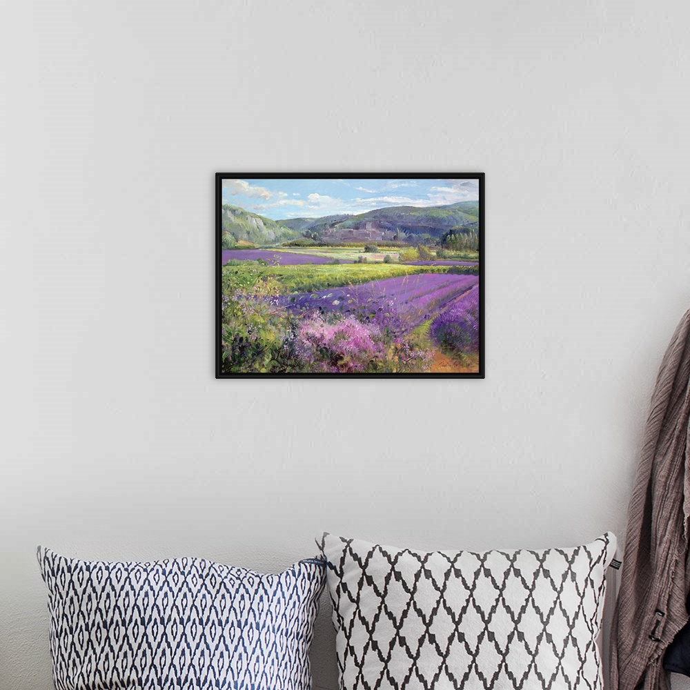 A bohemian room featuring Big painting of fields of lavender with rolling hills in the background. Cooling tones are featur...