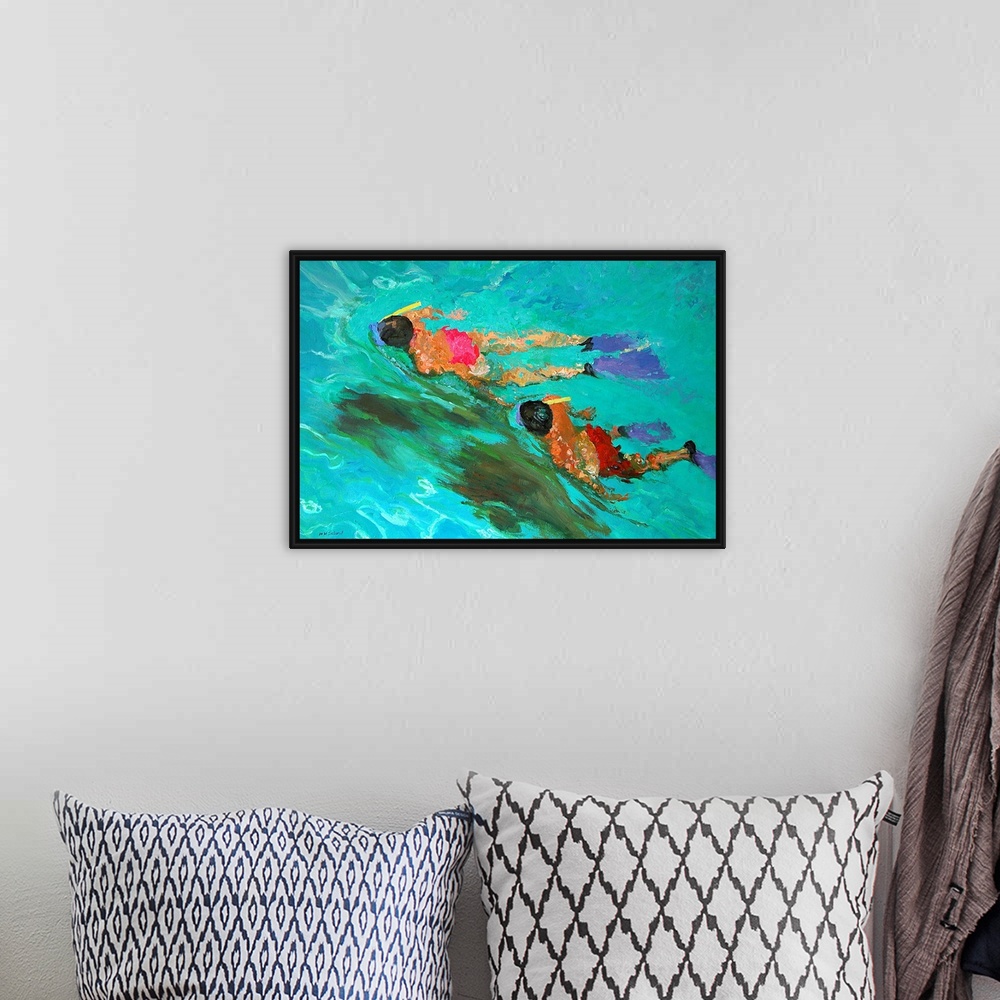 A bohemian room featuring Huge contemporary art shows a man and woman snorkeling through clear water.  As the two people tr...