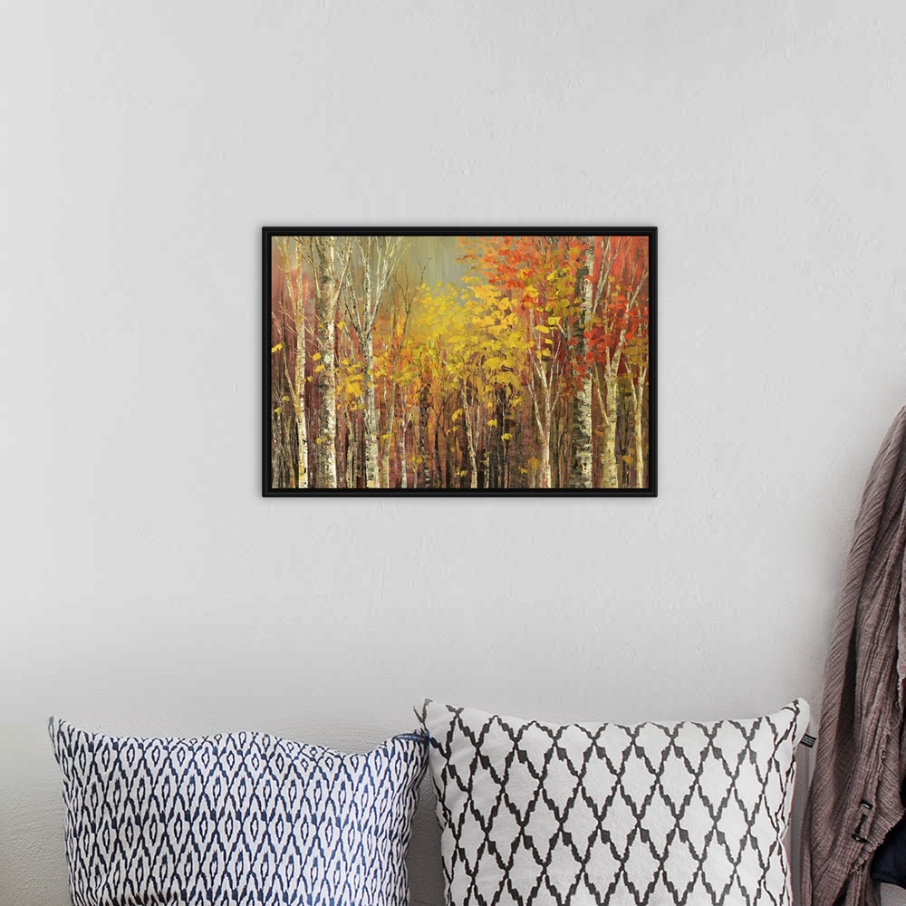 A bohemian room featuring Painting of a grove of trees in bright fall colors.