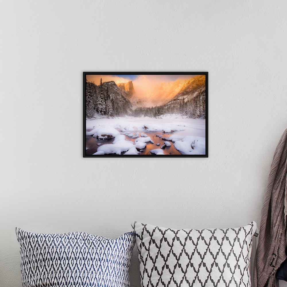 A bohemian room featuring Giant photograph of a snow covered landscape filled with trees surrounding and a frozen river run...