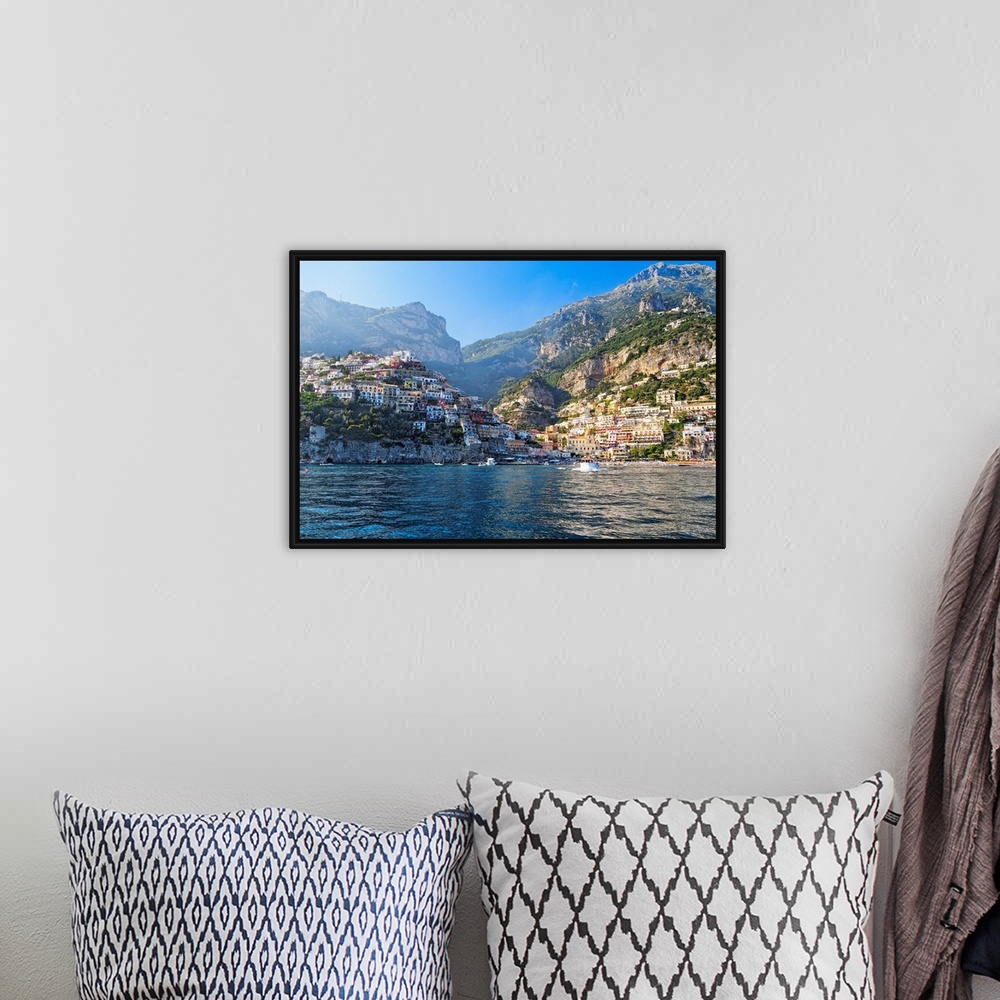 A bohemian room featuring Fine art photo of the Mediterranean town of Positano nestled in the hills, seen from the ocean.