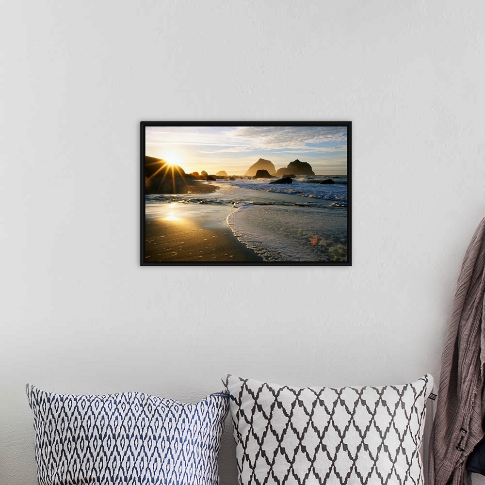 A bohemian room featuring Panoramic photograph displaying a sunset over an ocean and sandy beach.  In the background you ca...