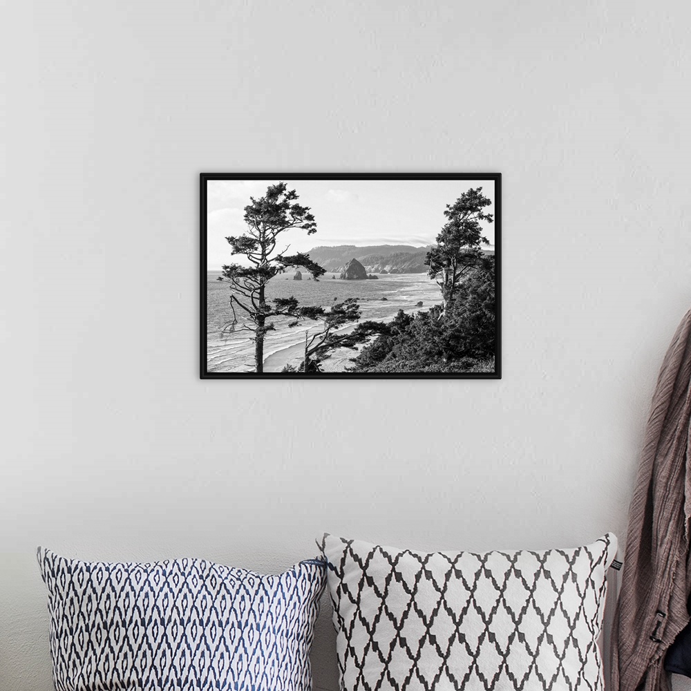 A bohemian room featuring Black and white landscape photograph of Cannon Beach through the trees with Haystack Rock in the ...