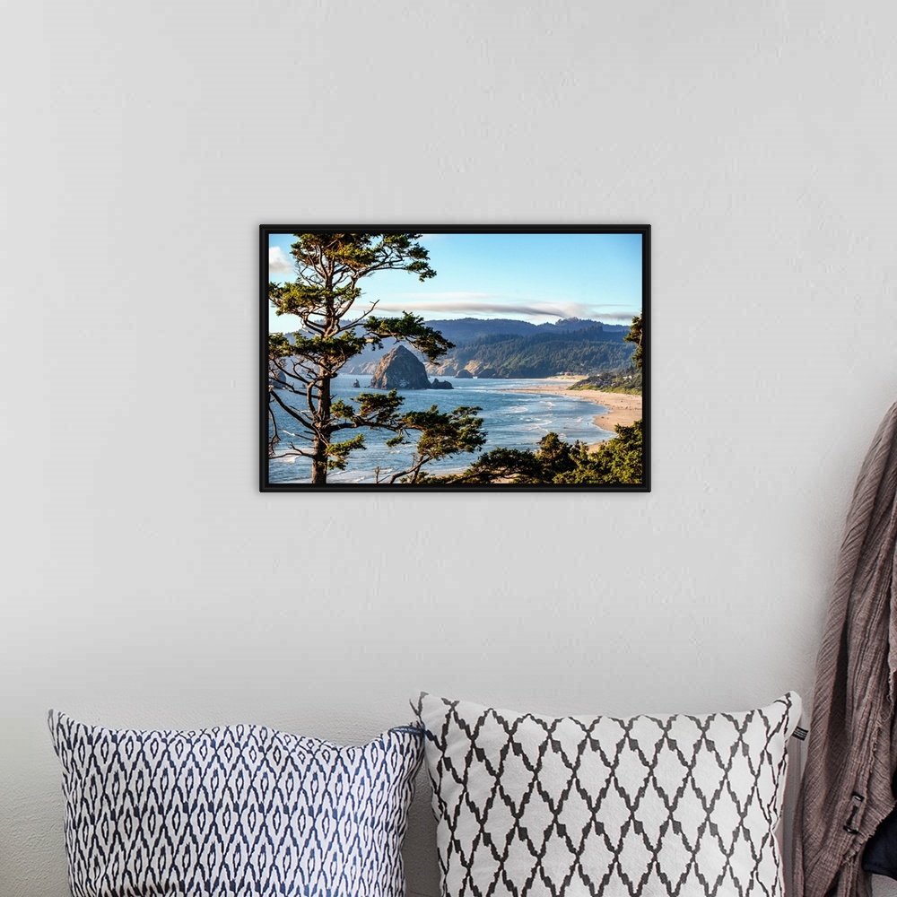 A bohemian room featuring Landscape photograph of Cannon Beach through trees with Haystack Rock in the distance.