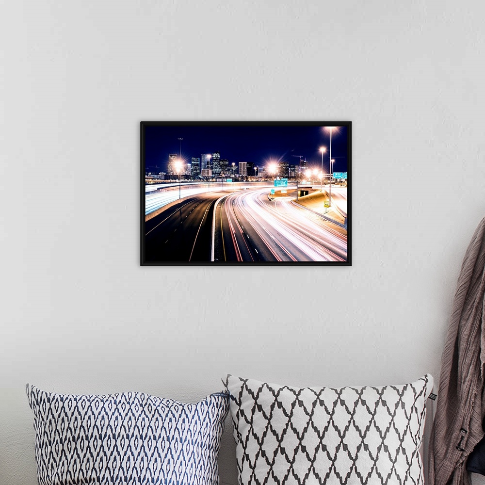 A bohemian room featuring Photo of light trails against Denver's night skyline.