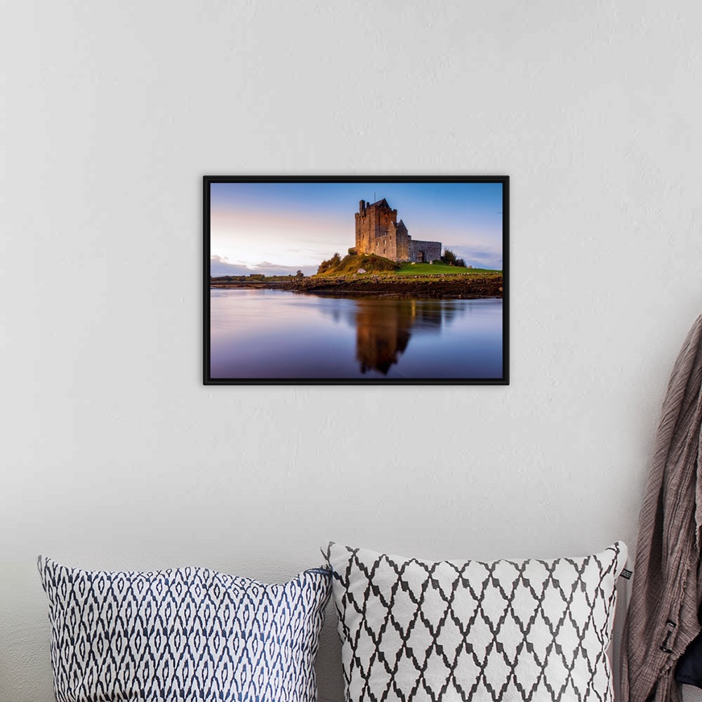 A bohemian room featuring Landscape photograph of the Dunguaire Castle reflecting into the water on the southeastern shore ...