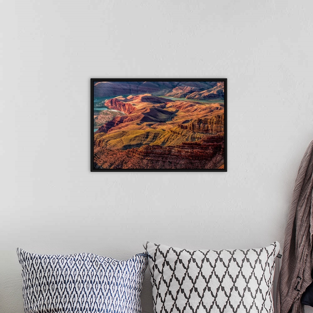 A bohemian room featuring Landscape photograph of the Colorado River winding through the Grand Canyon.