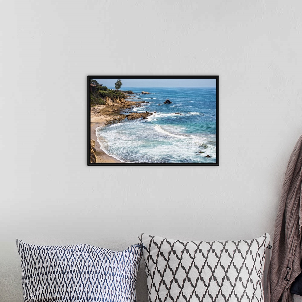 A bohemian room featuring Little Corona del Mar beach is relatively small, flanked on both sides with rocky reefs.
