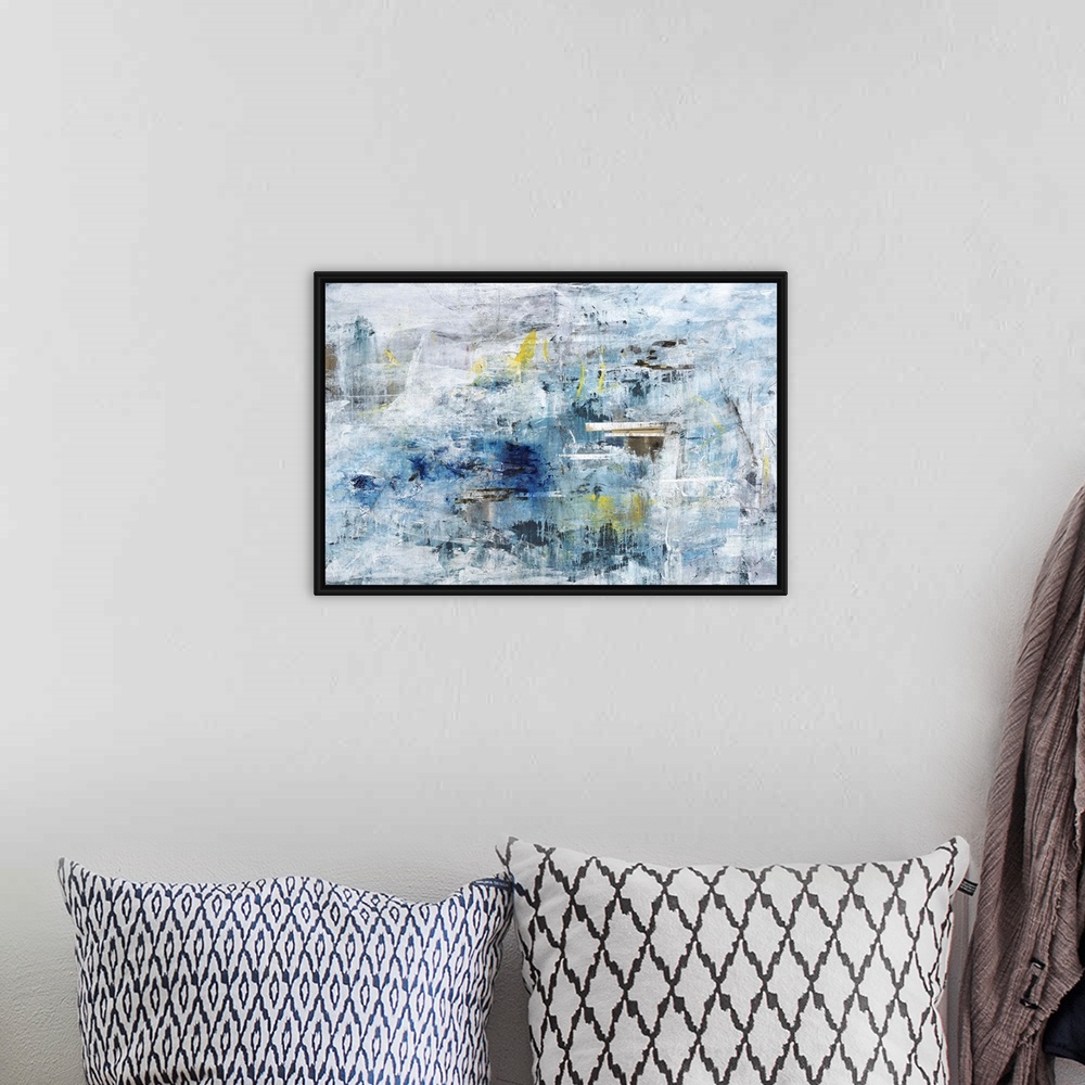 A bohemian room featuring A textured abstract painting in shades of blue and gray with elements of yellow throughout.