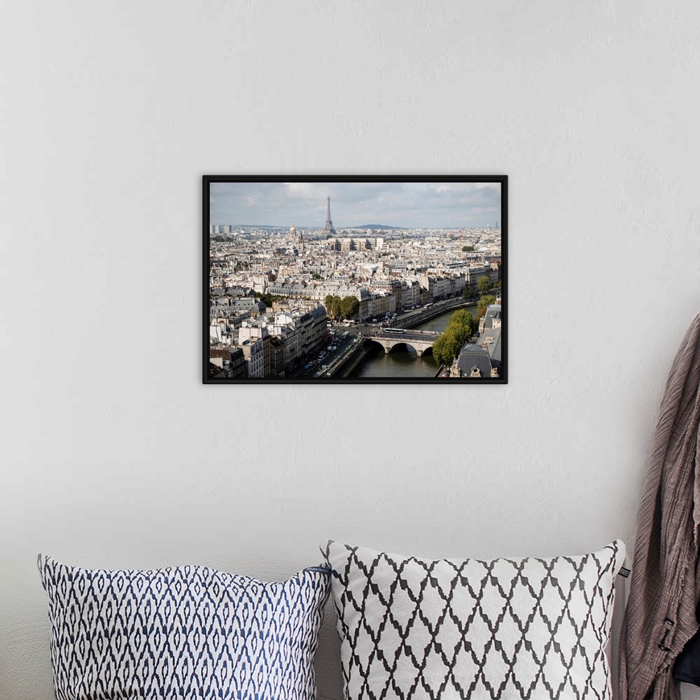 A bohemian room featuring Photograph of a Paris Cityscape with the Eiffel Tower towering over the city.