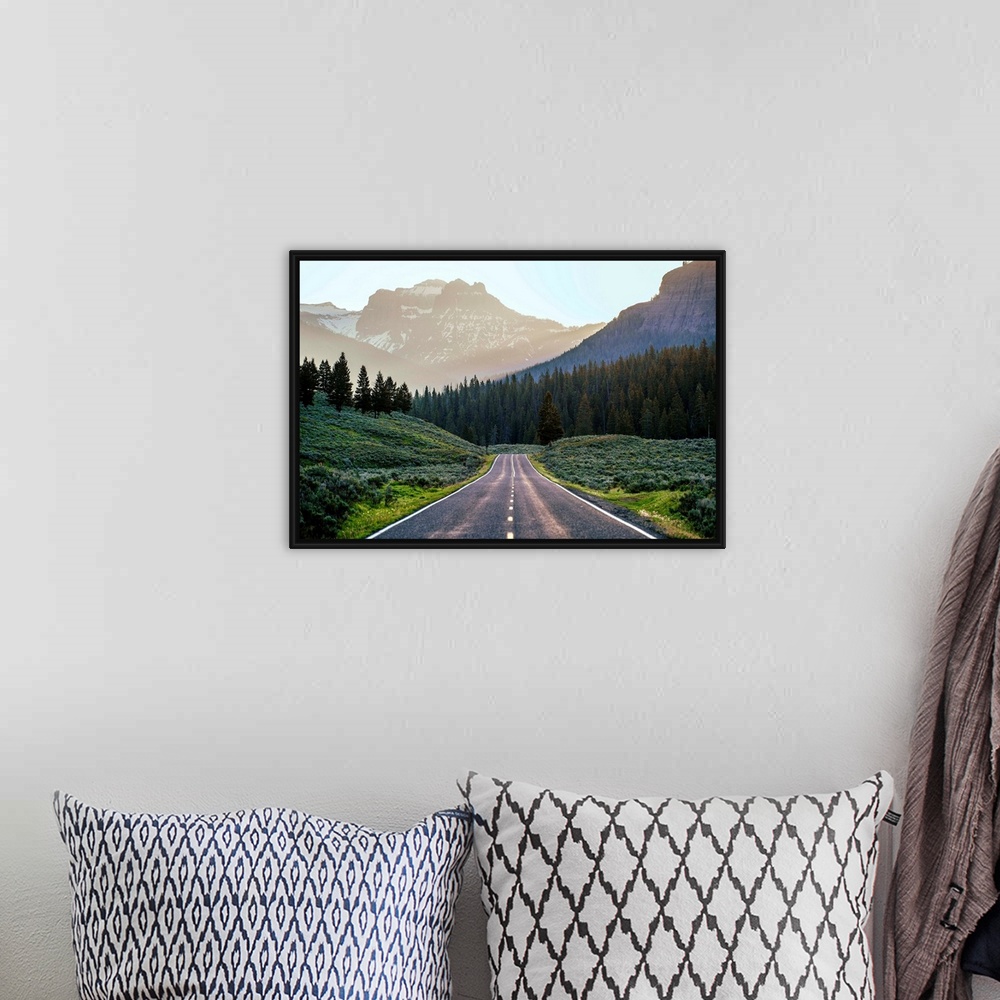 A bohemian room featuring Horizontal image of a road heading to the mountains at Yellowstone National Park.