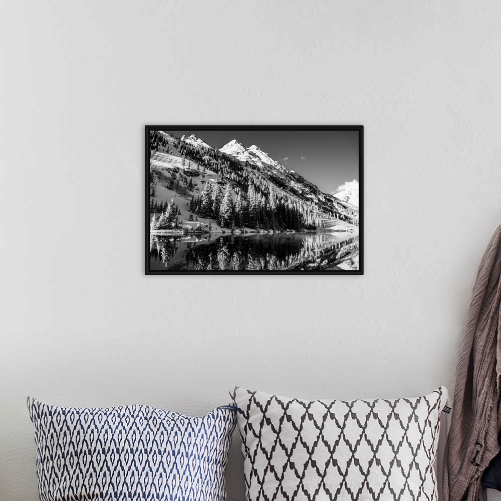A bohemian room featuring Summer snow on pine trees and the mountain side at the edge of Maroon Lake in the Maroon Bells, A...