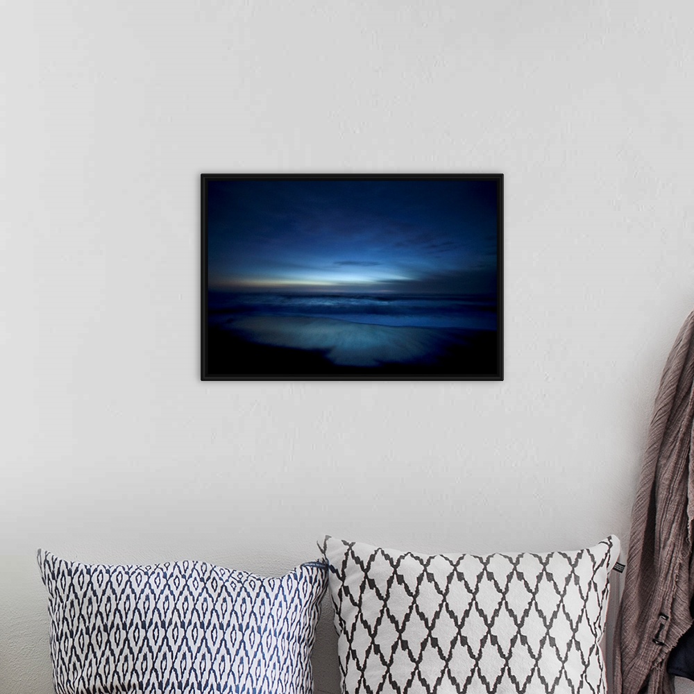 A bohemian room featuring Landscape, oversized photograph of deep blue ocean waters along the beach, surrounded by the dark...