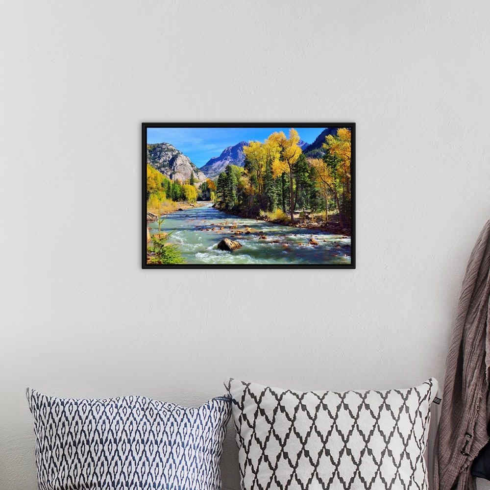A bohemian room featuring mountain river and colorful mountains of Colorado.