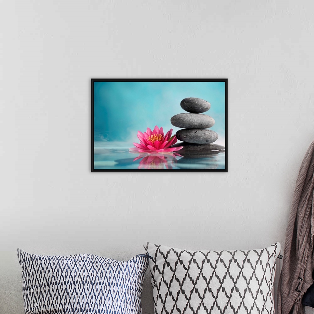 A bohemian room featuring Spa still life with water lily and zen stone in a serenity pool.