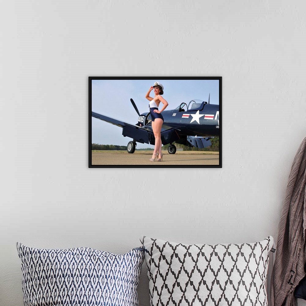 A bohemian room featuring Beautiful 1940's style Navy pin-up girl posing with a vintage Corsair aircraft.