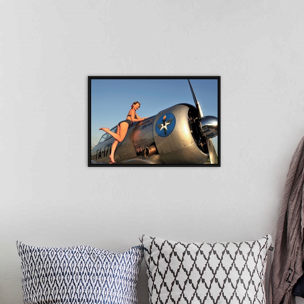 A bohemian room featuring 1940's style pin-up girl standing on the wing of a World War II T-6 Texan.