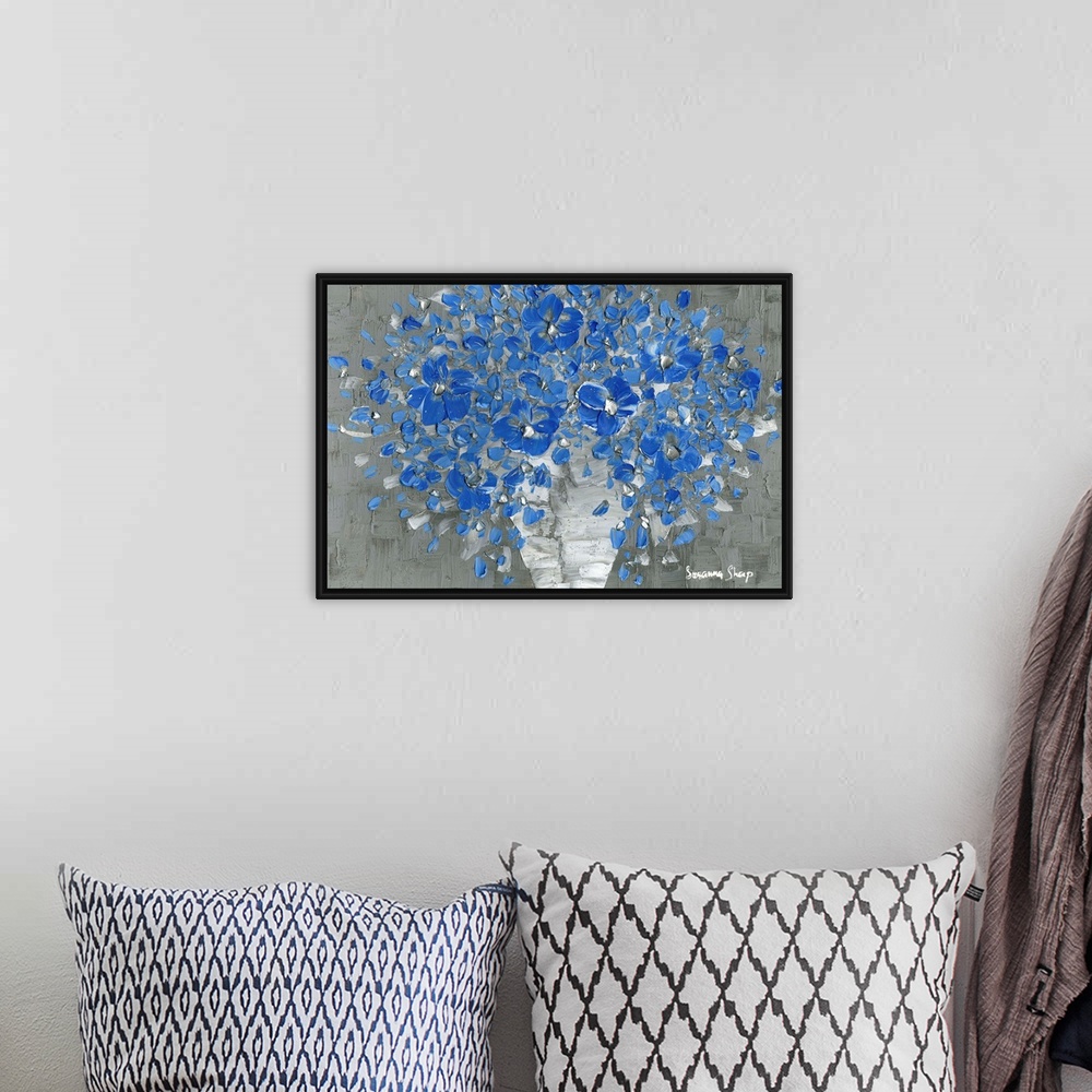 A bohemian room featuring Contemporary painting of a bouquet of blue flowers with silver highlights in a white vase with a ...