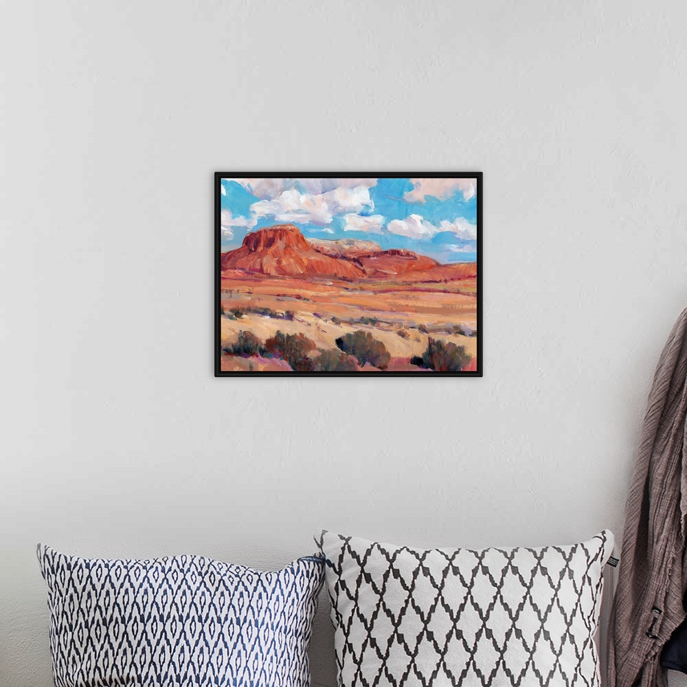 A bohemian room featuring Contemporary landscape painting of a bright blue cloudy sky overlooking a desert.