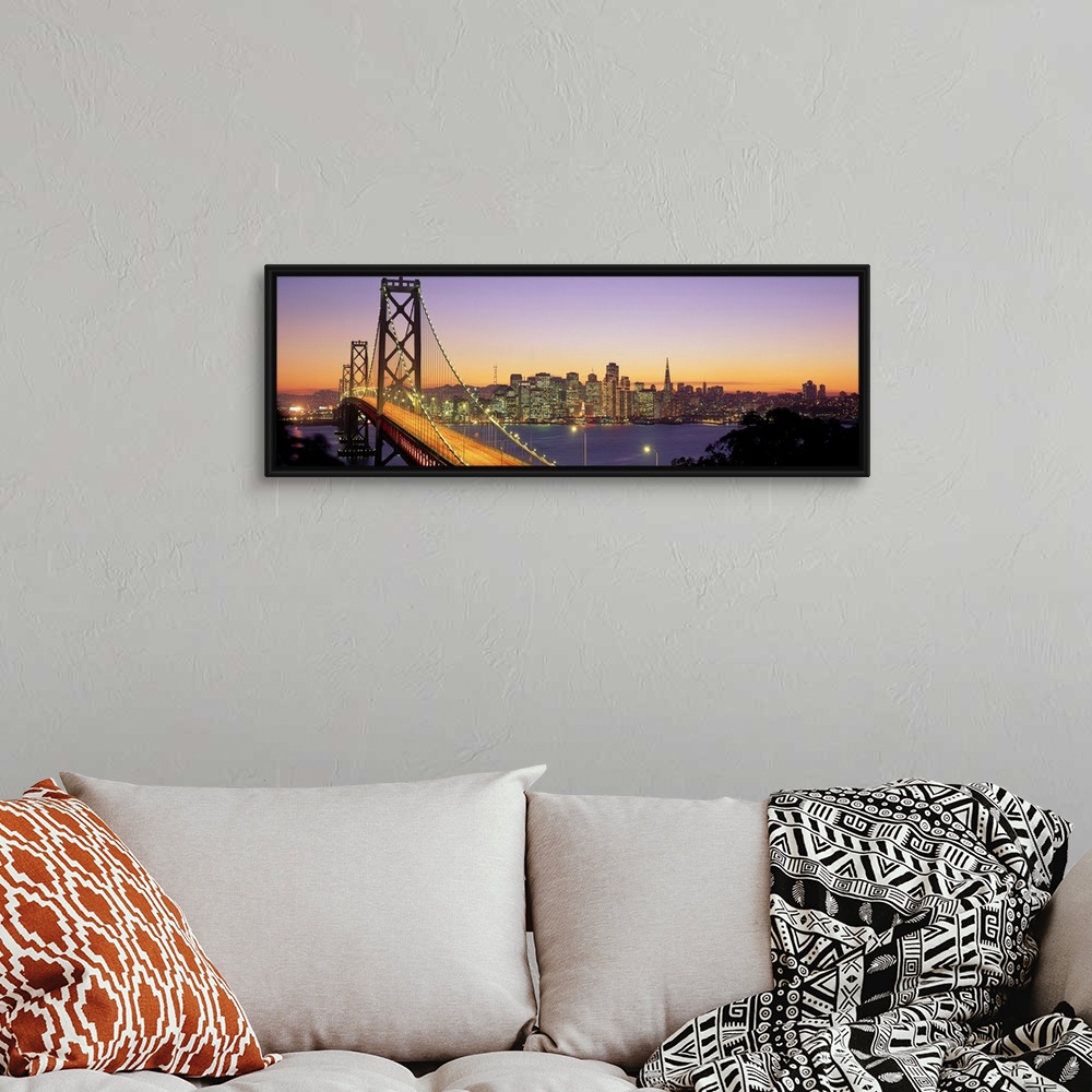 A bohemian room featuring Twilight and the Golden Gate Bridge with the San Francisco Skyline with a purple and gold sky.