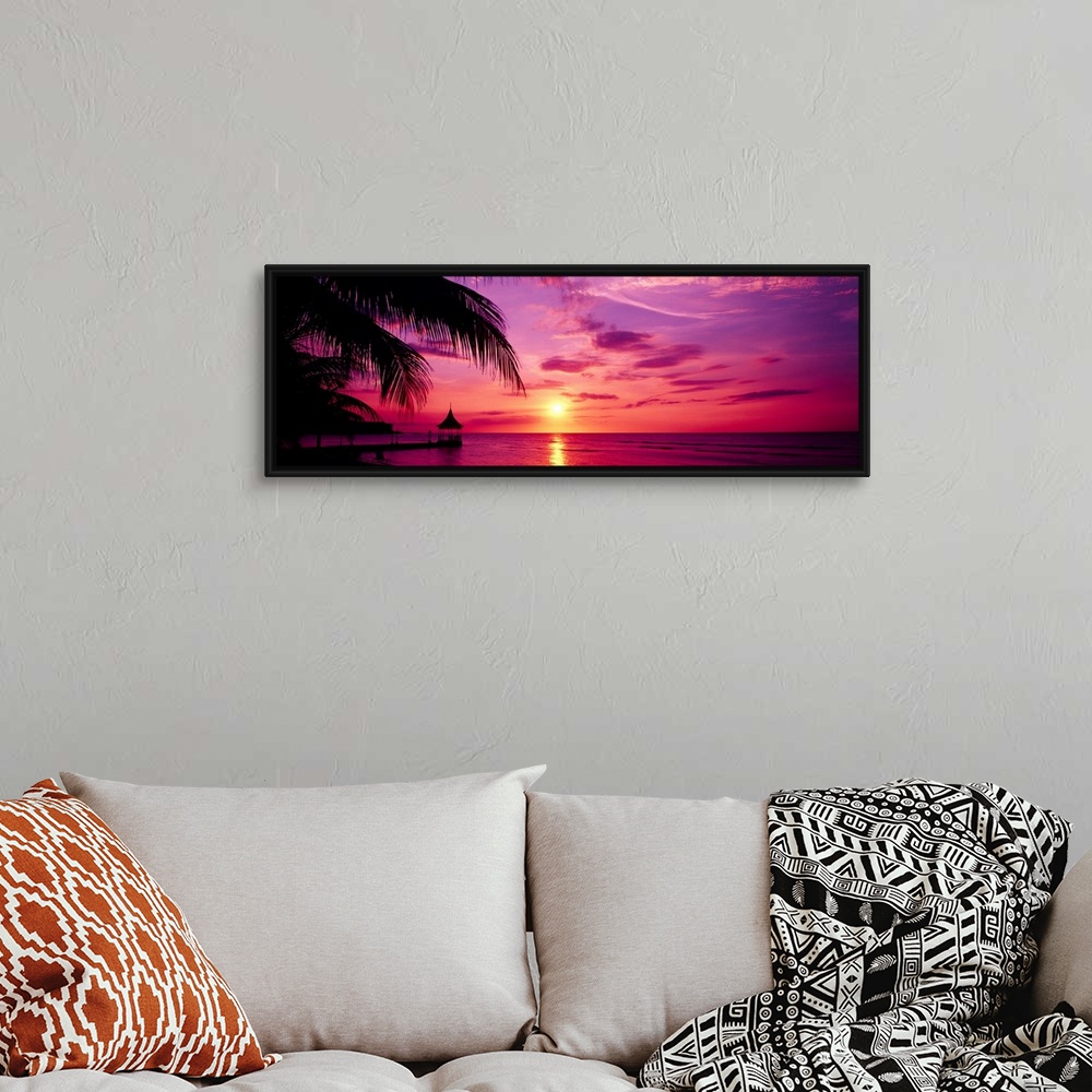 A bohemian room featuring Panoramic photograph of a colorful sunset on the beach in Montego Bay, Jamaica.  The palm trees a...