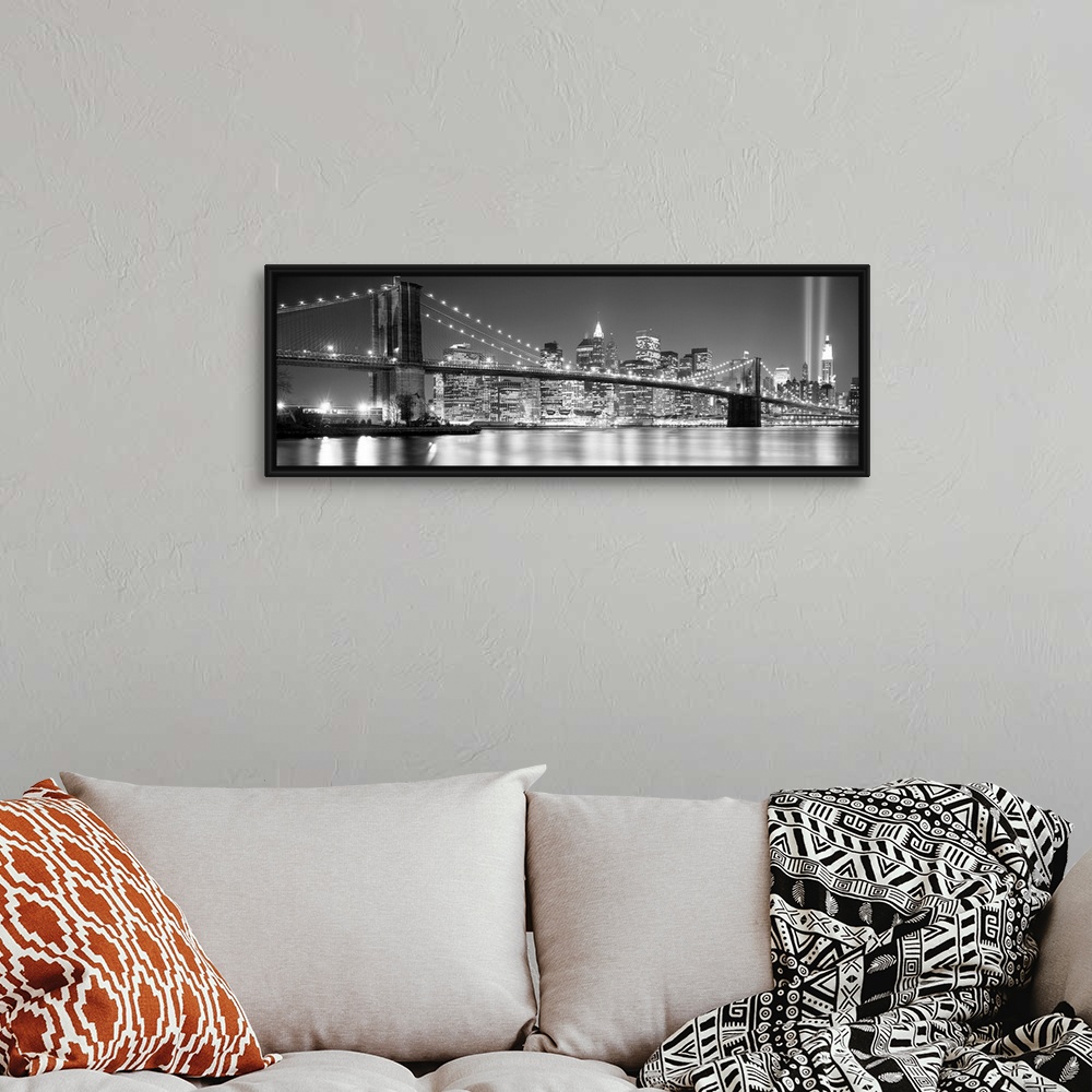 A bohemian room featuring A panoramic landscape photo taken after 2001 of Manhattan and Brooklyn Bridge shining bright over...
