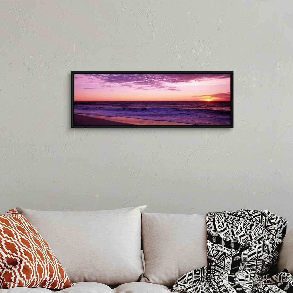 A bohemian room featuring Small waves washing up on shore as the sunrises in this landscape photograph.