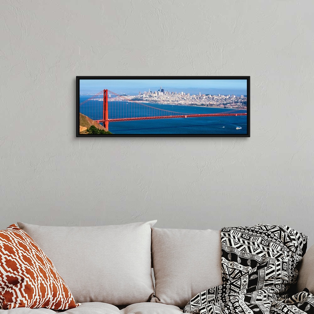 A bohemian room featuring Panoramic photograph of the Golden Gate Bridge with San Francisco's skyscrapers in the background.