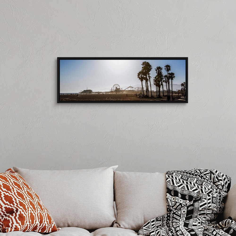 A bohemian room featuring Panoramic photograph of the Santa Monica Pier in Los Angeles, California, with palm trees in the ...