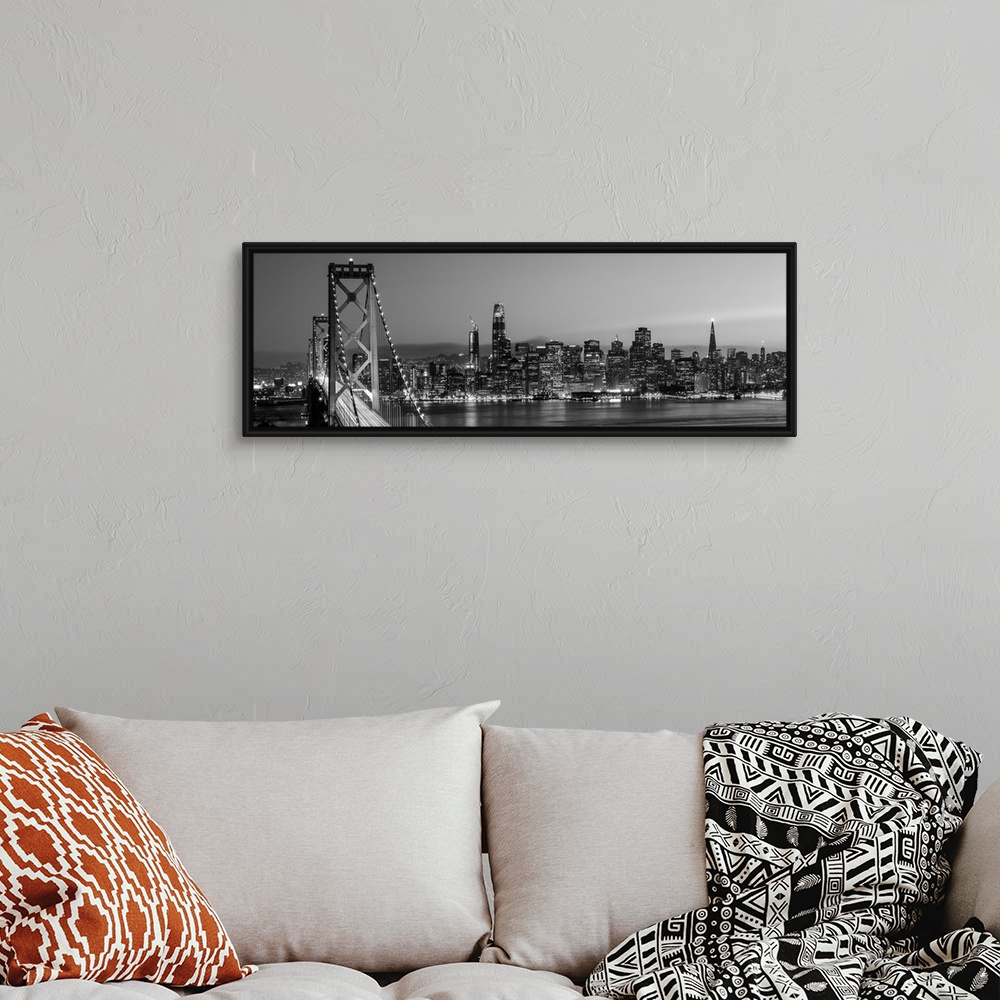 A bohemian room featuring Photograph of the Bay Bridge and the San Francisco skyline lit up at dusk.