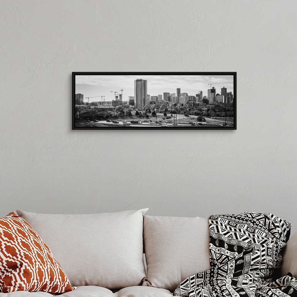 A bohemian room featuring Photograph of the Denver, Colorado skyline with cloudy skies above.