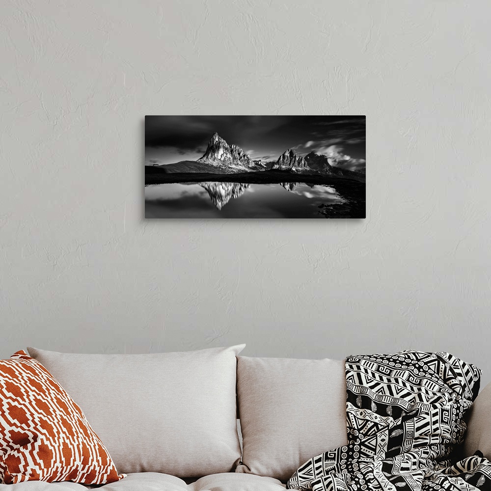 A bohemian room featuring Black and white panoramic landscape photograph of the Dolomites, Italy with reflections on the lake.