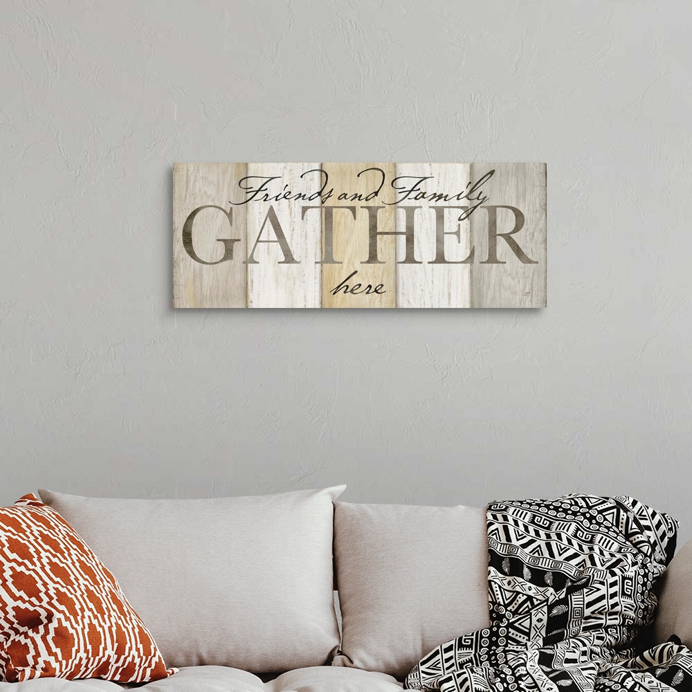 A bohemian room featuring "Friends and Family Gather here" on a neutral multi-colored wood plank background.